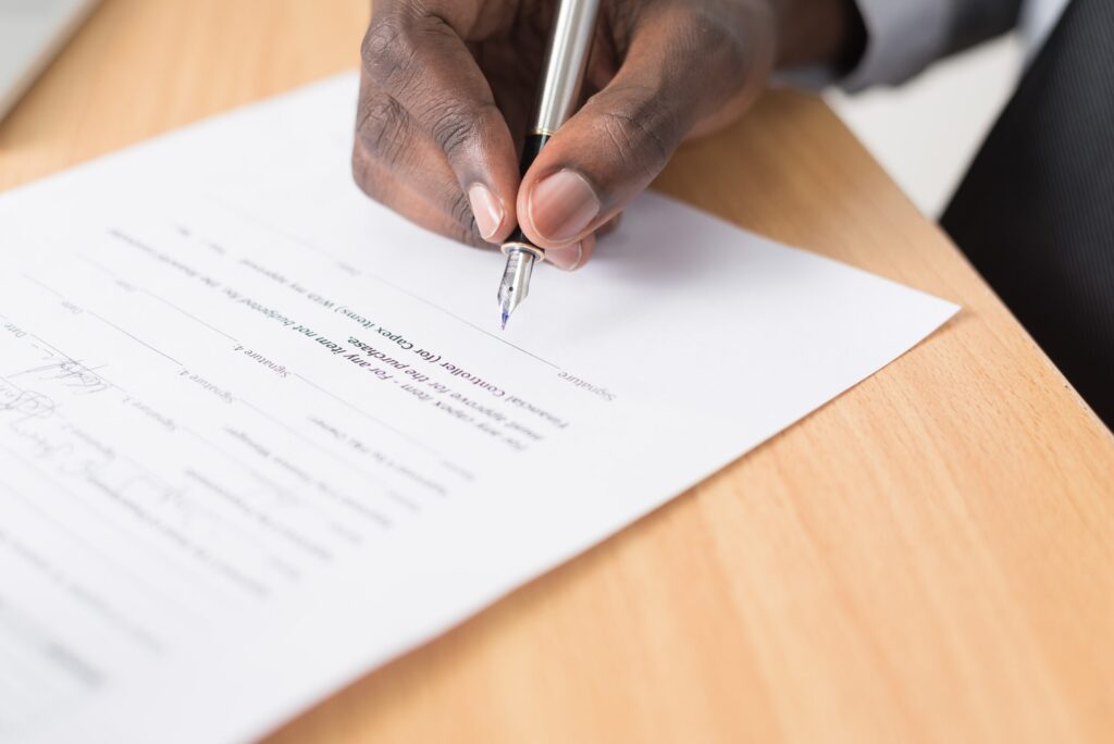 A man signing a contract, possibly a divorce